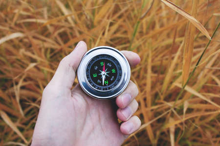young man hand compass