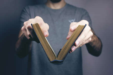 young man reading a bookの写真素材