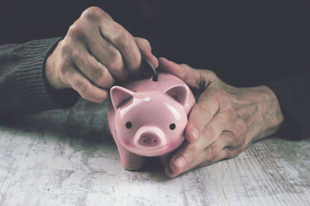grandmother and piggy bankの写真素材