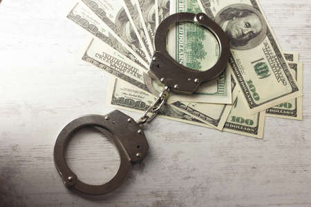 handcuffed money on the tableの写真素材