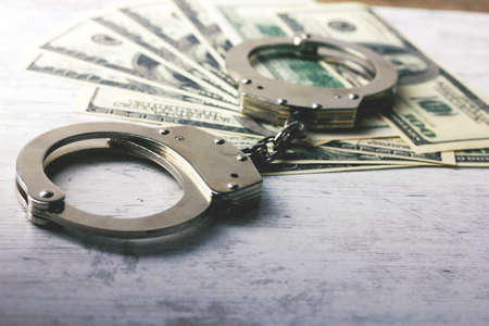 handcuffed money on the tableの写真素材