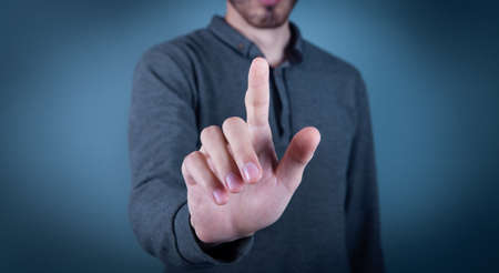 Hand pushing on a touch screen.の写真素材
