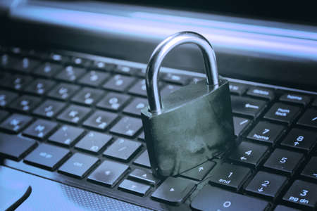Lock on laptop as computer protection and cyber safetyの写真素材