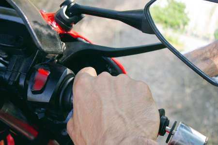 man holds a motorcycle gas knobの写真素材