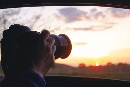man takes a sunset photo