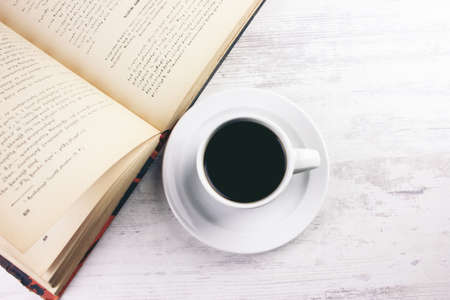book with black coffee on the tableの写真素材