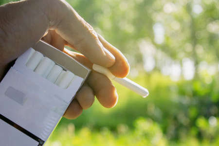 young guy holding a cigaretteの写真素材