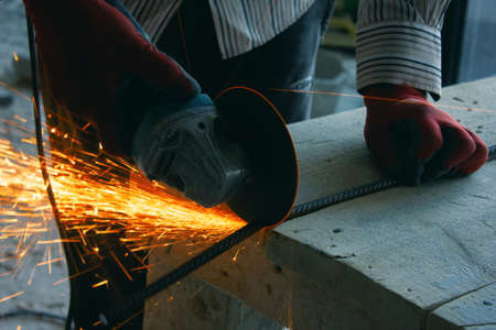 Manual worker work in factory with grinderの写真素材