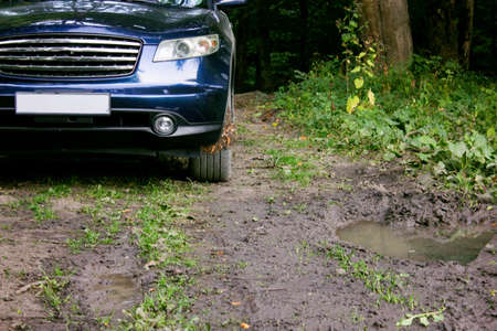 the car is driving on a bad road in the forestの写真素材
