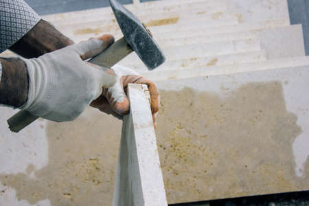man works with a stone