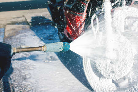 cleaning red sportbike in the car wash