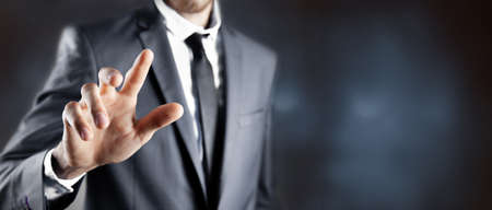 business man presses on touch screenの写真素材