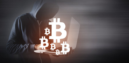 Hacker man using laptop and computer with Bitcoinの写真素材