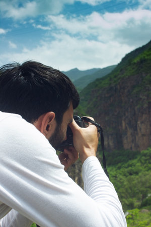 photographer photographs the sunset on the mountainsの写真素材