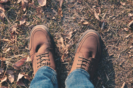 Legs of a man walking outdoors. Lifestyle fashion trendy style autumn season nature on background.の写真素材