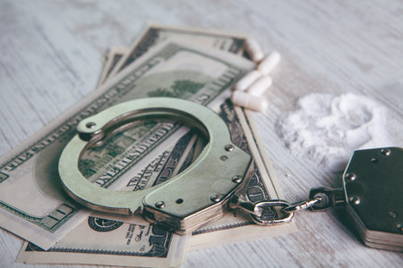 Drugs and handcuffs composition. selective focus. crime concept. Illegal money.の写真素材