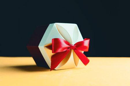 Gift box wrapped in kraft paper and bowの写真素材