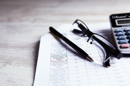 Close up calculator and financial report - accounting concept