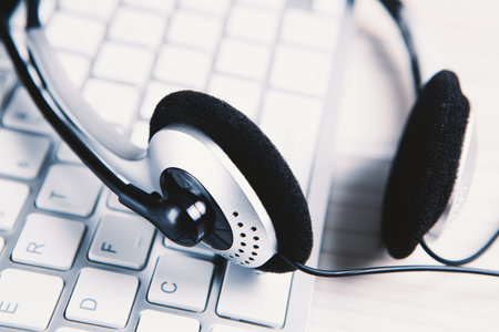 Headset on a laptop keyboard.の写真素材
