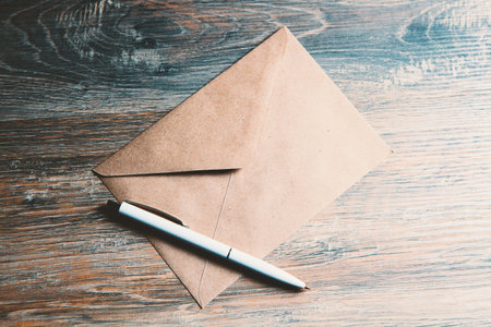 envelope with a pen on the tableの写真素材
