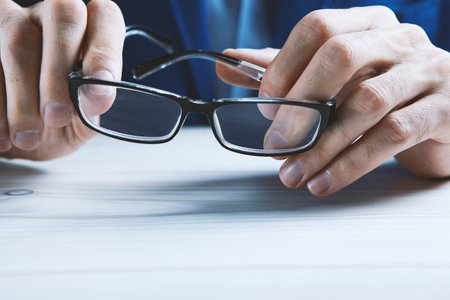man holds glasses in his hands.の写真素材