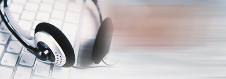 Headset on a laptop keyboard.の写真素材