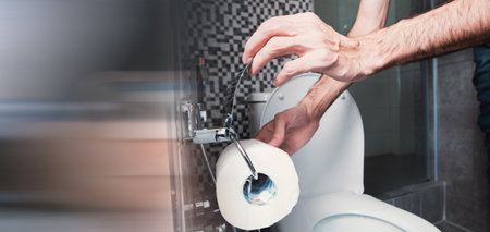 Person's Hand Using Toilet Paperの写真素材