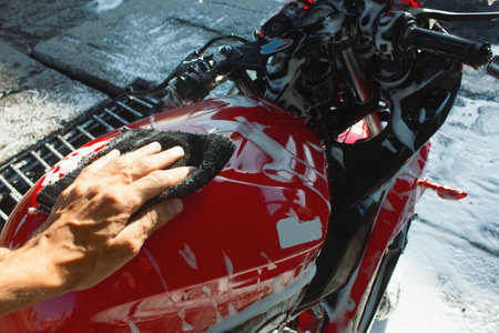 cleaning red sportbike in the car wash