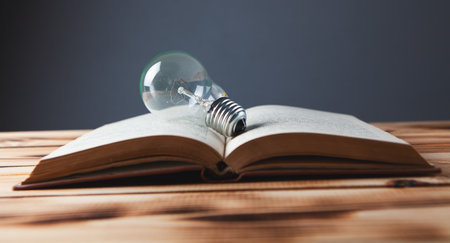 knowledge and wisdom, light bulb on the bookの写真素材