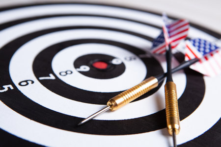 dart arrow hitting in the target center of the dartboard.の写真素材