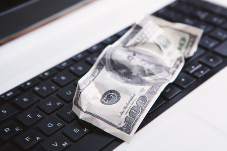 100 dollar bill on computerの写真素材