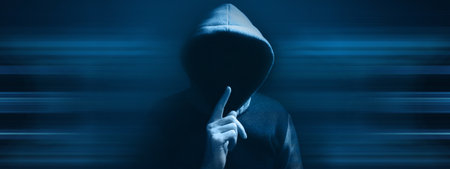 hooded man making silence gestureの写真素材