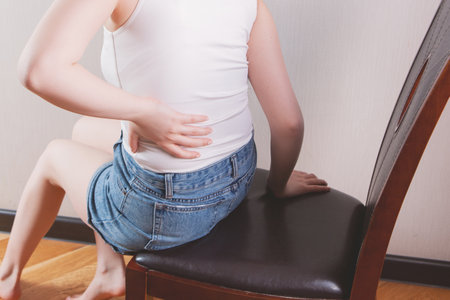 a young girl's back hurts.