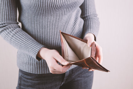 girl holding an empty wallet in her hand