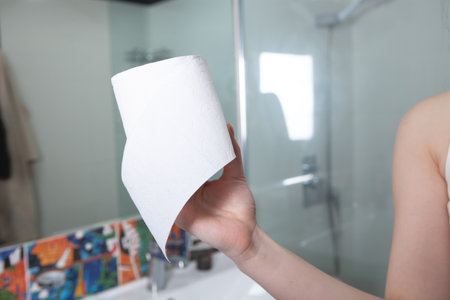 girl holding toilet papers in her hands.の写真素材