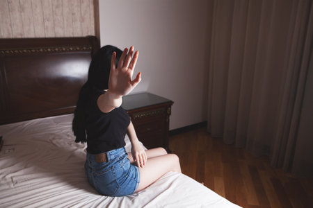 Closeup image of a woman outstretched hand and showing stop hand signの写真素材
