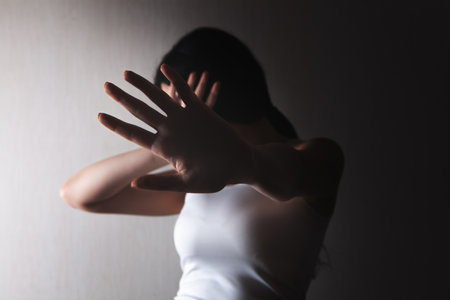 Closeup image of a woman outstretched hand and showing stop hand signの写真素材