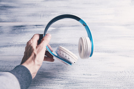 man holding headphones in her hand