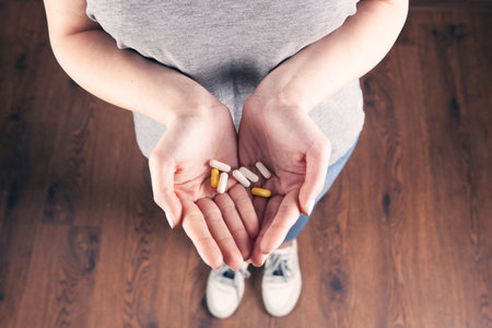 woman hand holding pillsの写真素材