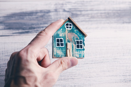 Family care and protection insurance concept. model of a small house