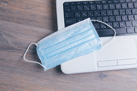 medical mask on the keyboardの写真素材