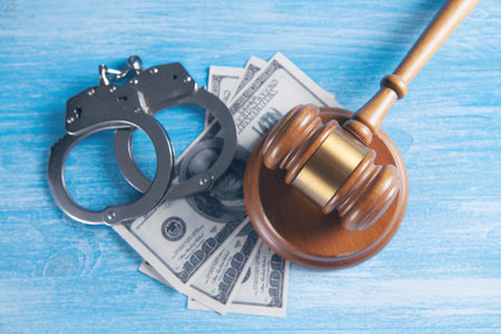 Legal law concept image - gavel and handcuffs and money