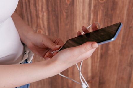 the girl put the phone on chargeの写真素材