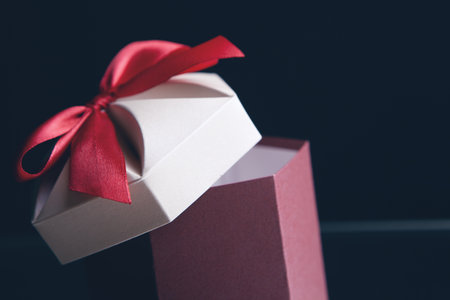 Gift box wrapped in kraft paper and bowの写真素材