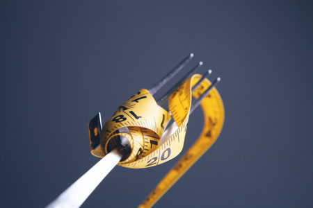 Dieting concept with fork and meterの写真素材