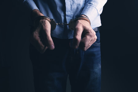men handcuffed in criminal conceptの写真素材