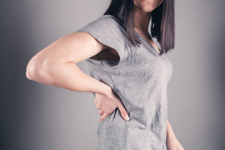 a young girl's back hurts.