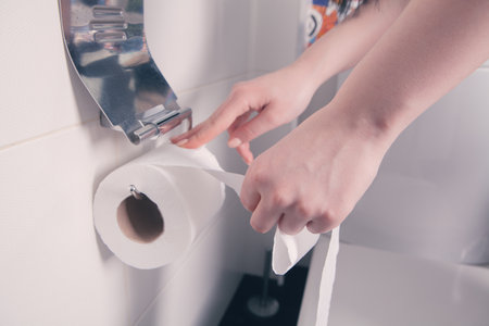 girl holding toilet papers in her hands.の写真素材