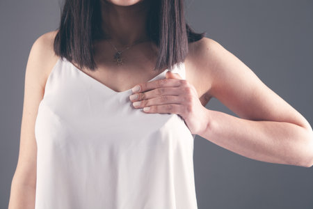 girl presses her hands on her chest chest pain