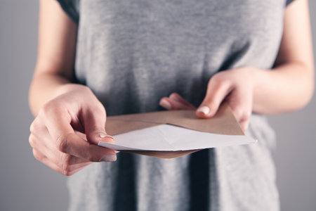 girl holding mail correspondence in her handの写真素材